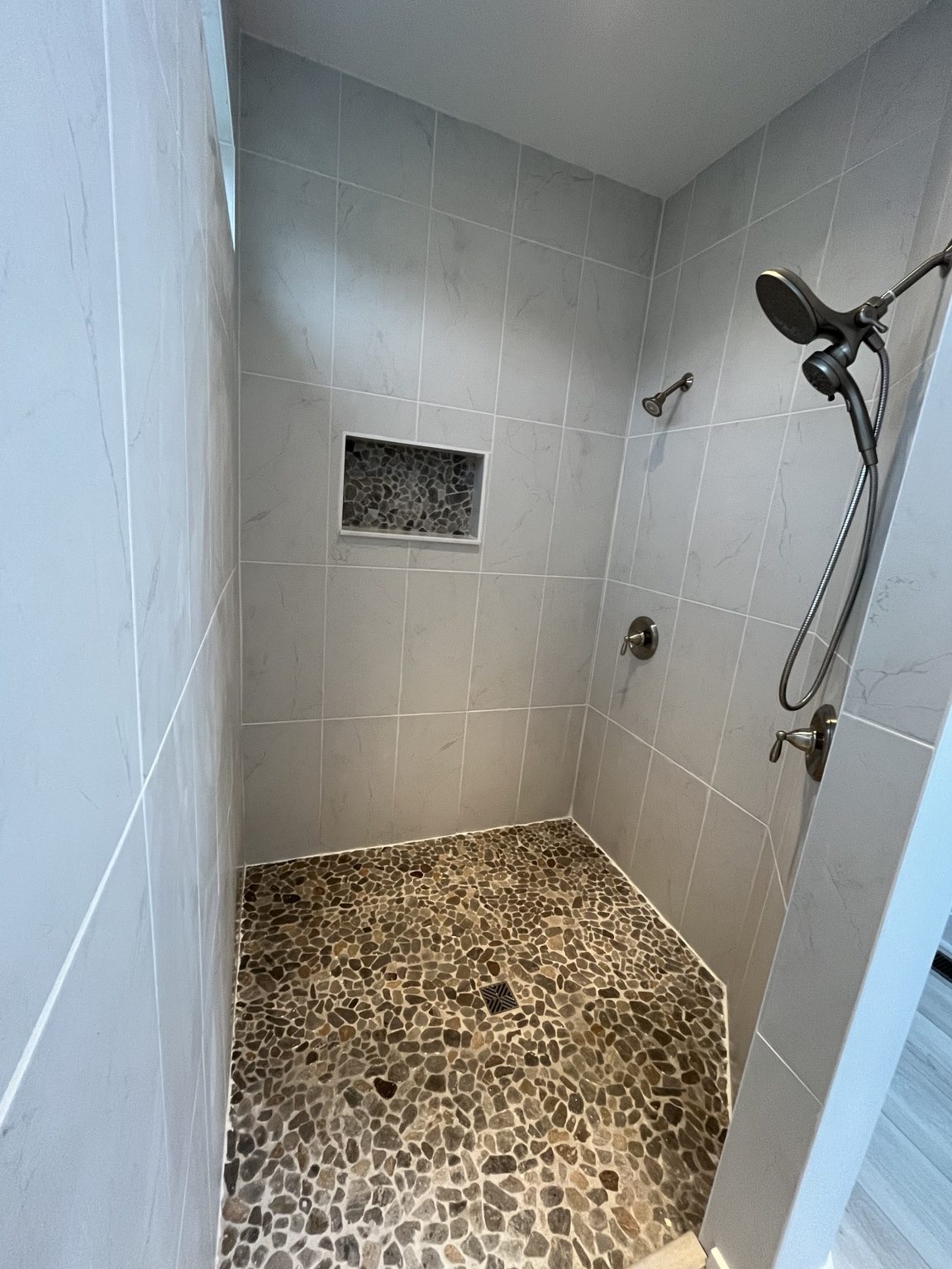 Pebble floor tile shower