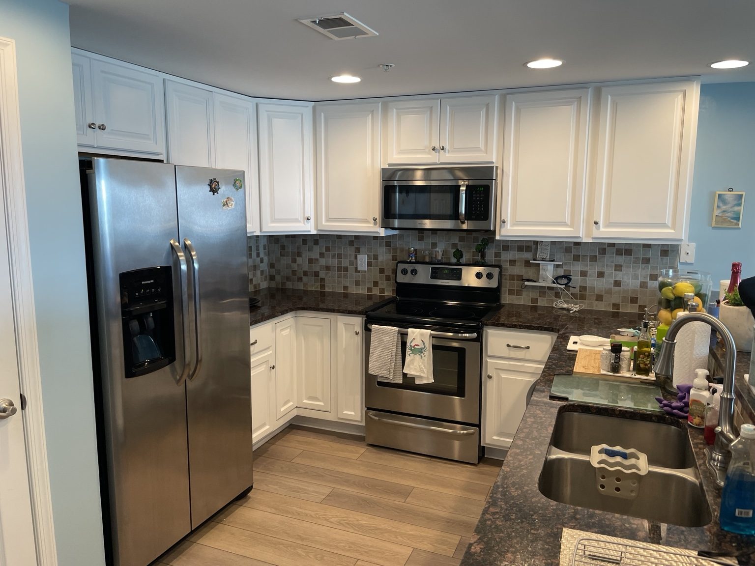 Coastal kitchen with white cabinets